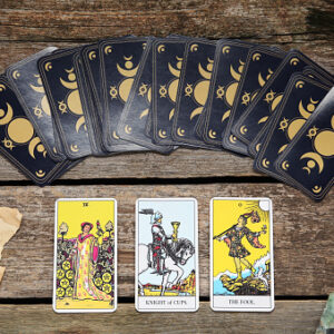 Tarot cards, peacock feather, gemstones and old book on wooden table, flat lay